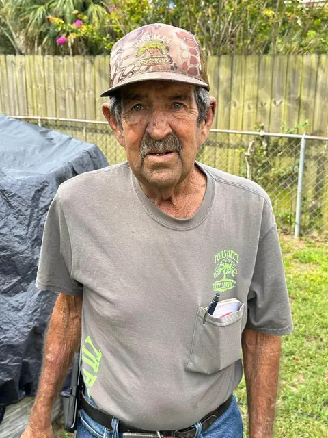 Larry Forshee, founder of Forshee's Tree Service, standing in his back yard