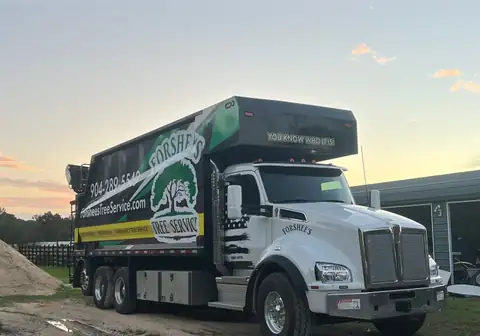 Forshee's Tree Service Kenworth T880 grapple truck parked at sunset